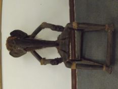 Unusual rocking chair in the form of a figure with the head of an elephant, constructed from black