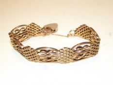 A 9ct yellow gold gate bracelet with safety chain