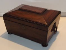 Early 19th century rosewood tea caddy, sarcophagus form with bead and reed detail and ring pull