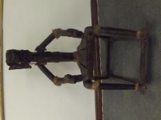 Unusual rocking chair in the form of a figure with the head of an elephant, constructed from black