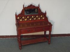 Late Victorian wash stand in mahogany, the tiled back with central mirror, above two apron drawers