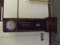 1930's art deco long case clock in oak, circular dial with Arabic numerals, three weight movement,