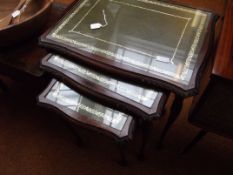 Nest of three tables with tooled leather tops