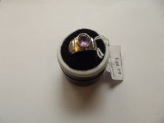 Silver ring with large purple stone