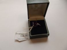 Silver ring with large purple stone