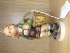 Goebel figure of a boy holding basket