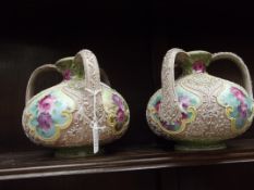 2 early three handled vases