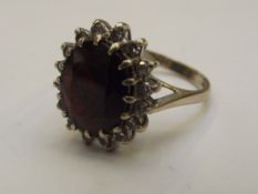 18 carat gold dress ring with large garnet surroun