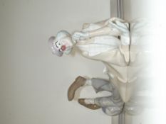 A large Lladro figure of a clown laying down 38x15