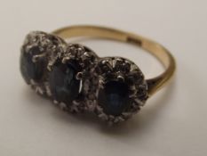 18 carat gold 3 stone sapphire and diamond ring, e