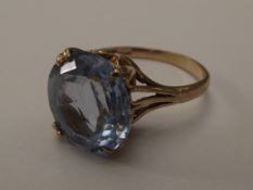 9 carat gold dress ring set with large blue gemsta