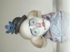 A large Lladro bust of a sad clown resting his hea