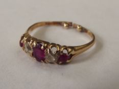 Five stone ruby and diamond ring set in a yellow m