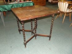 Oak drop leaf side table on barley twist supports,