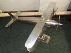 Large model of a biplane, constructed from polishe