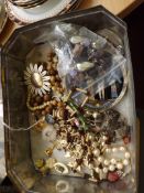 Tin of costume jewelry