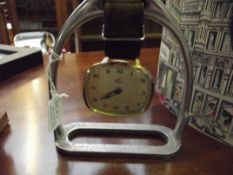 Novelty clock suspended from a saddle