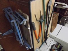 Assorted gardening tools together with a workmate