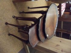 Nest of three tables in walnut, pie crust edges an