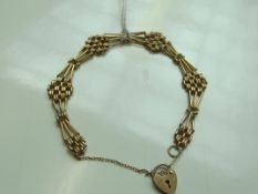 9 carat gold bracelet with heart lock and safety c