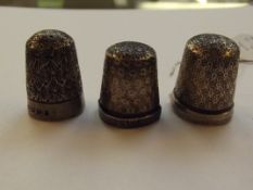 Three silver thimbles, one of which bearing Cheste