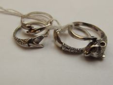 Four silver dress rings