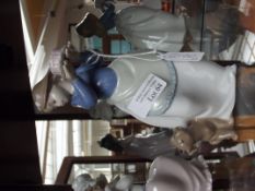 Nao figure of a girl holding cake with puppy