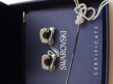 Swarovski earrings together with a Swarovski pin b