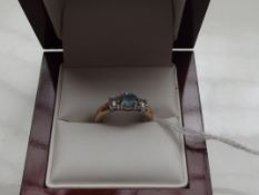 9 ct gold CZ ring with central blue stone