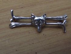 Silver stamped brooch, riding crop and foxes head