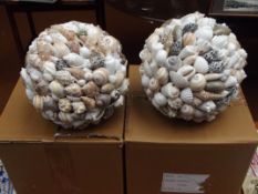 Two circular balls covered in shells