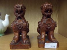 Pair of carved treen Chinthes