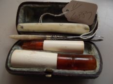 Two cheroot holders, a pen knife and tweezers