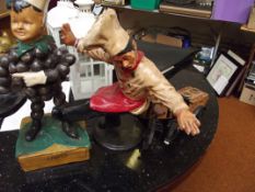 Two baker figures and two bickes