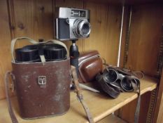 Two sets of vintage field glasses together with a