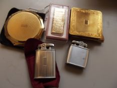 Two compacts together with three cigarette lighter