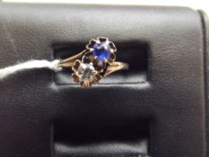 Yellow metal 2 stone dress ring with white and blu