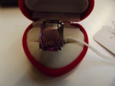 Silver ring with a large purple stone