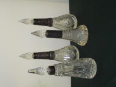 Group of four Late Victorian/Edwardian silver mounted and cut glass scent bottles