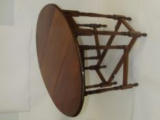 Early 20th century oak drop leaf gate leg table, oval top above turned supports and feet, height