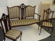Edwardian mahogany three piece drawing room suite comprising settee and two side chairs