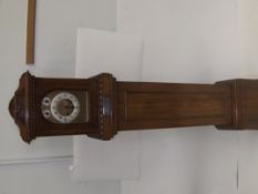 Edwardian oak longcase clock, arched hood enclosing a circular dial with Arabic numerals above an