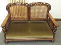 Early 20th century three piece oak bergere suite, scroll top rail, cane backs, cup and cover