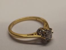 18ct gold and diamond ring. Solitaire central half
