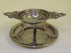 Silver twin handled tea strainer with integral dri
