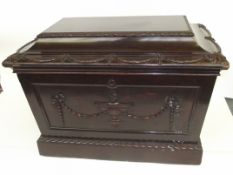 Early Victorian mahogany cellarette, sarcophagus form, swag decoration to the hinged lid and
