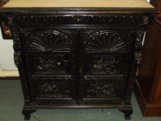Oak cabinet, top frieze drawer with writhen decoration above a blind cabinet, the panels depicting