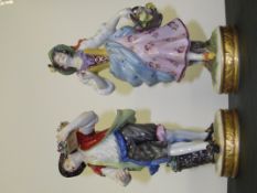 Late 19th/early 20th, pair of Continental figurines in the form of flower pickers, height 20cm