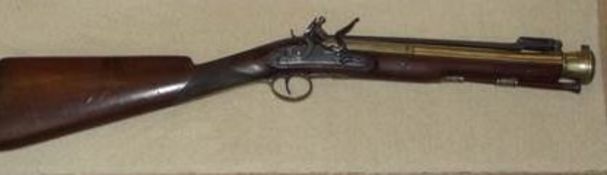 An early 19th century Blunderbuss. English Walnut, Brass and Steel Flintlock by the makers Lacy &