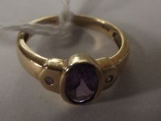 9 carat gold dress ring set with amethyst flanked